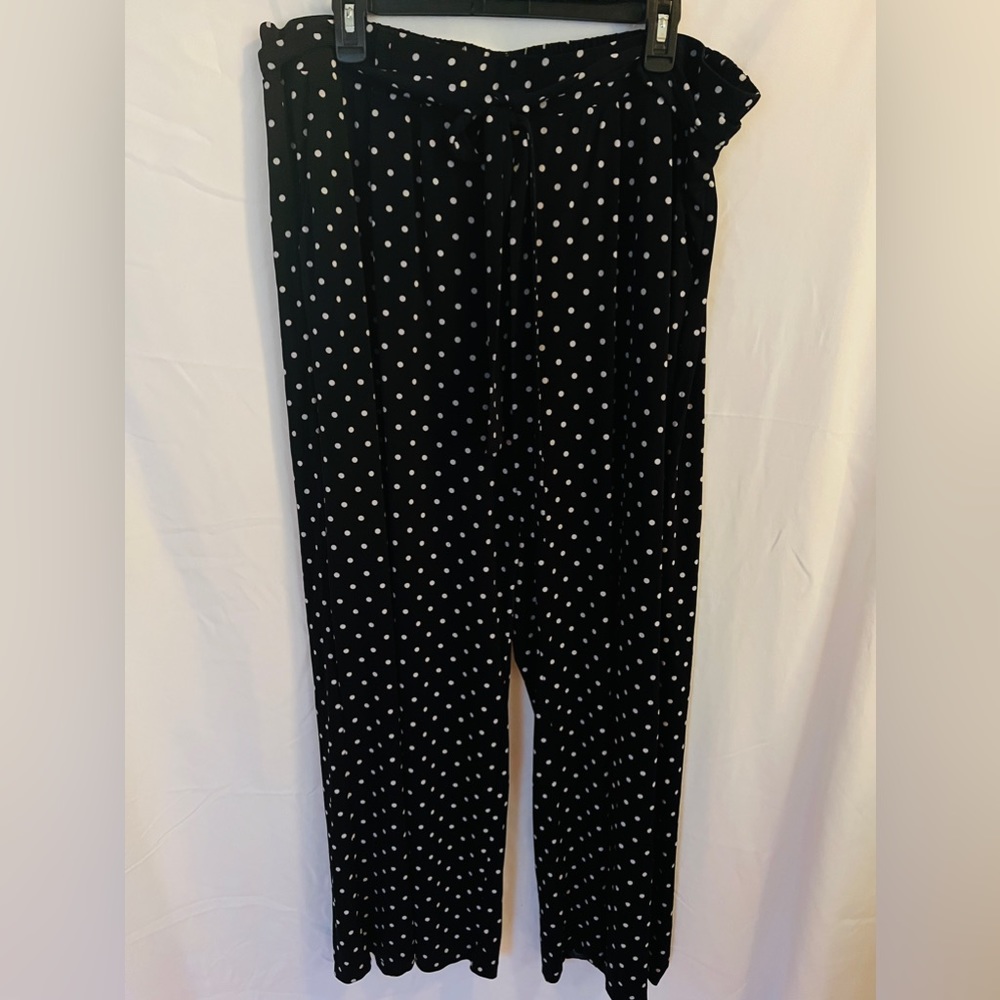 Loose fitting polka dot wide legged dress pants with front tie.